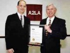 Hill Cox, (right) of the Canadian Central Gauge Laboratory receives the first non-U.S. ISO Guide 25 accreditation from American Association for Laboratory Accreditation president Pete Unger.