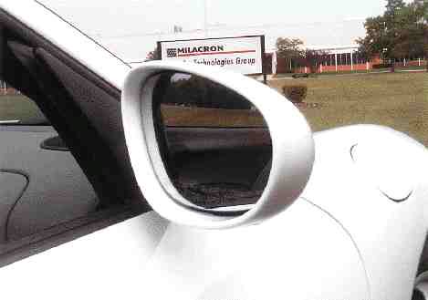 Side mirror for the Porsche Boxster sports car is molded using Milacron's Airpress III process. The patented gas-assist process first fills the mold cavity completely with melted resin before the controlled introduction of gas, providing highly uniform wall thickness and superior surface finish.