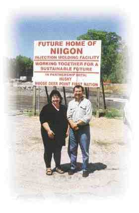Rhonda King, Moose Deer Point First Nation director of economic development, and Bob Dickson, Niigon Technologies Ltd.'s general manager, stand near the entrance to the facility's construction site. The plant is scheduled to open this fall with one to three injection molding machines and approximately six employees.