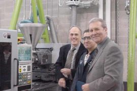 Admiring the new machine are (left to right) David Alcock and Hamid Mohammadi of CPTC, and Glen Billinger of Plastics Machinery Inc., which represents Sumitomo.